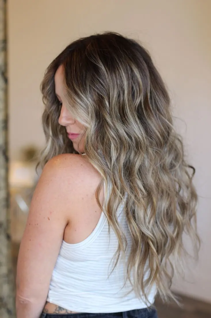 Balayage blonde extensions styled in loose waves