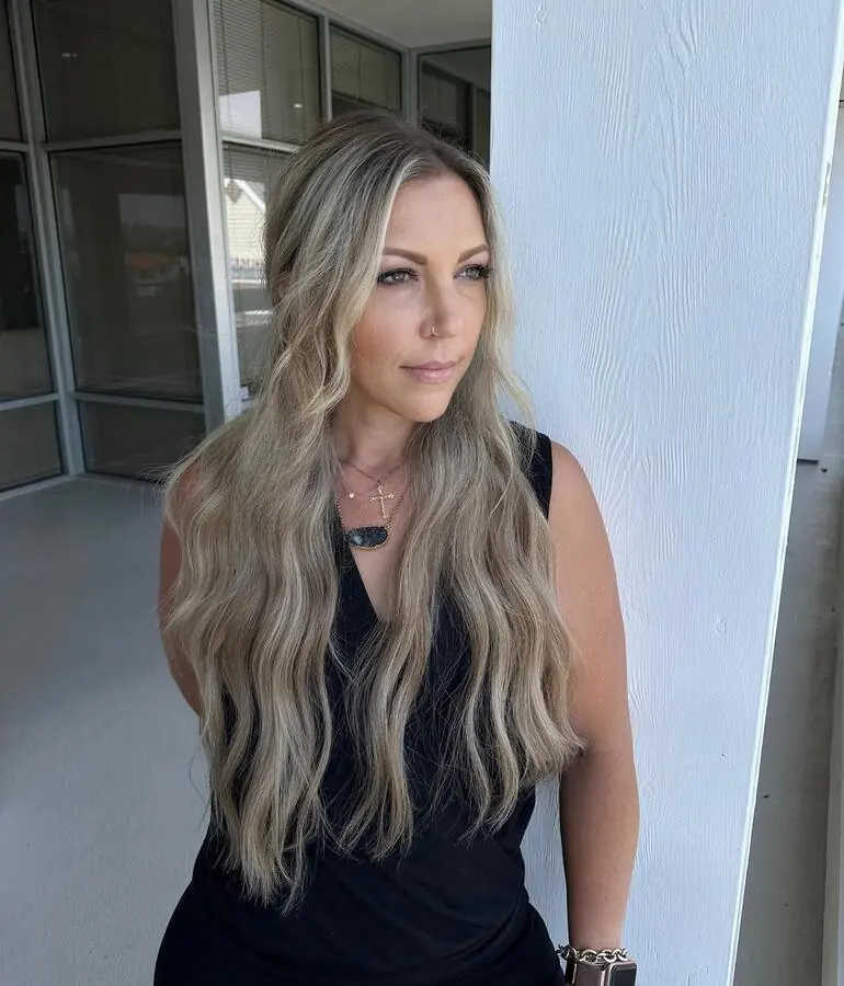 Guest with long blonde extensions outside the salon