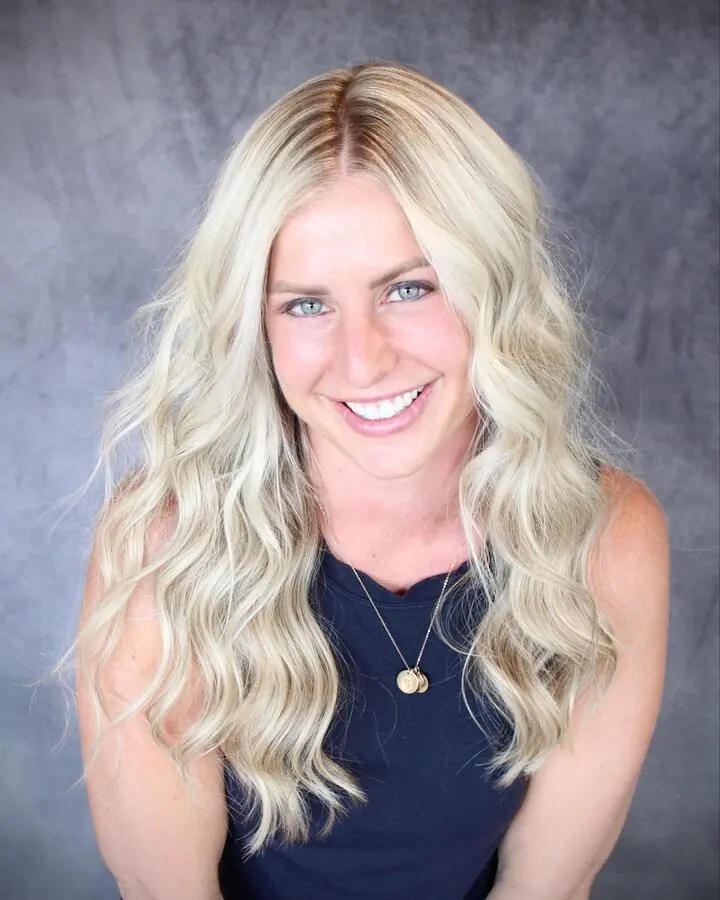 Blonde guest smiling after her appointment